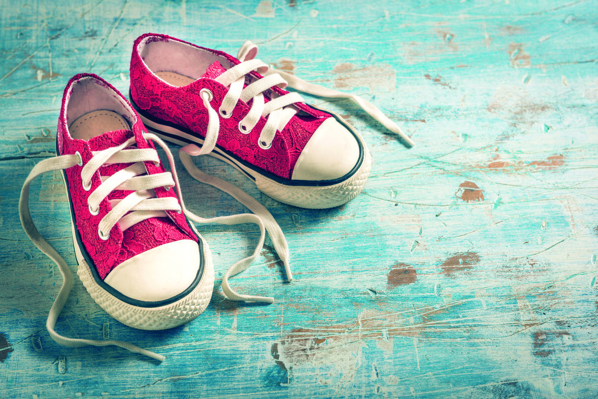 Pair of red sneakers on a blue wood floor