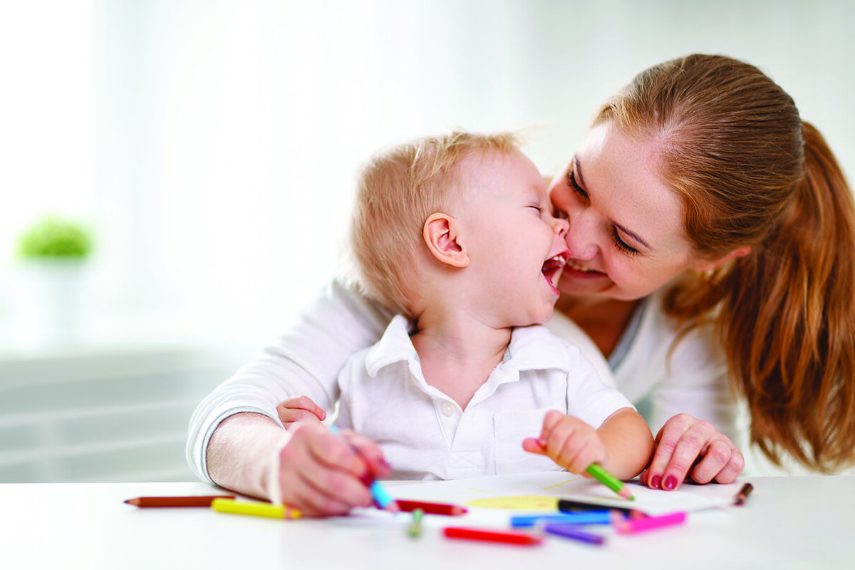 Mother and toddler laughing together