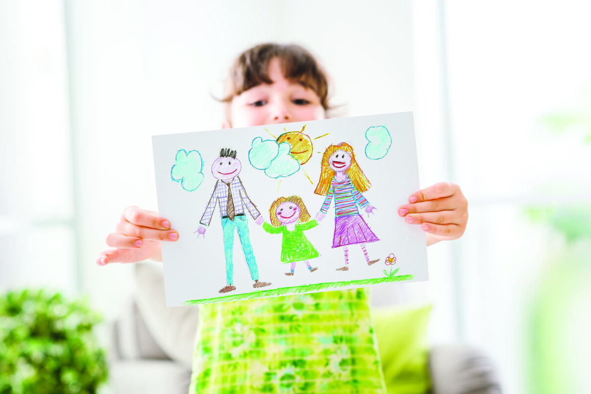 Child holding family drawing